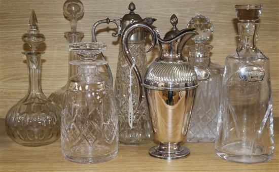 A collection of decanters and claret jugs